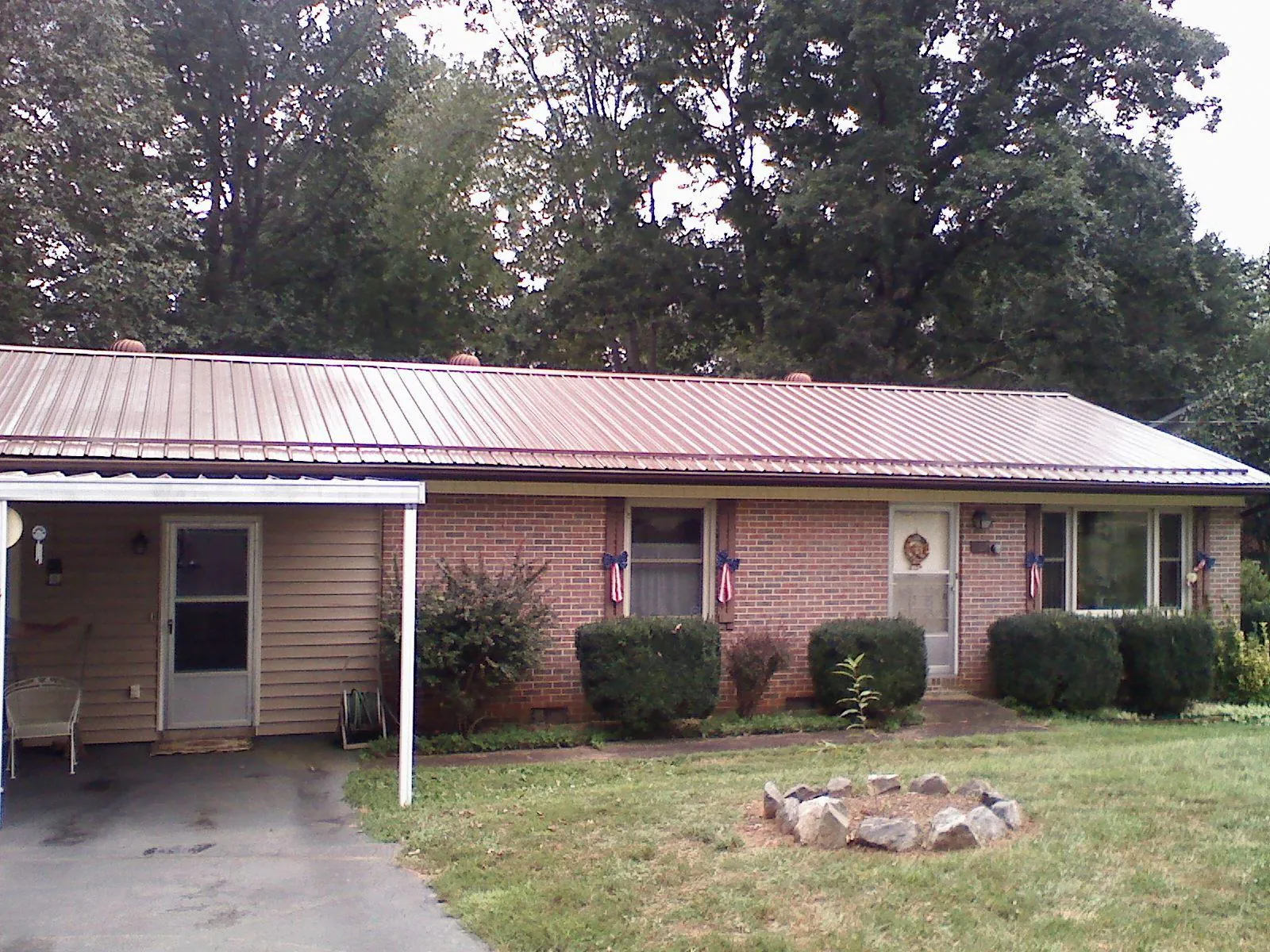 Bronze metal roof and carport on a brick ranch home — Roof Repair work by our crew in Souderton